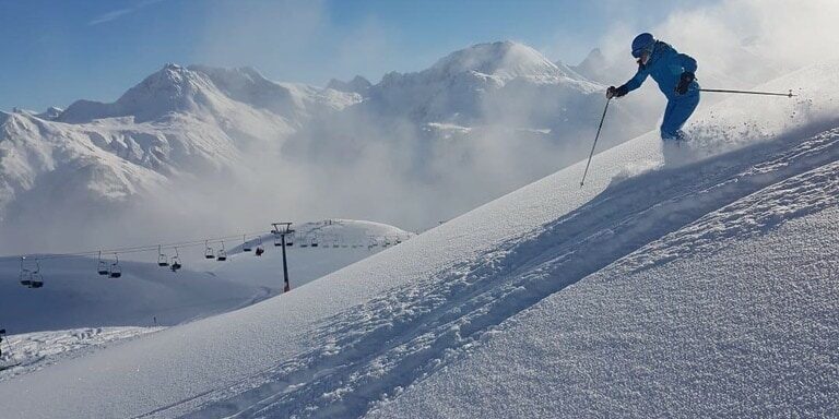 An interesting view of a freerider in snowy Lech onto the ski lift. 